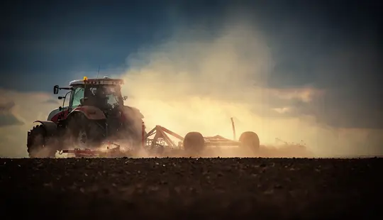 tractor ploughing field for reseeding